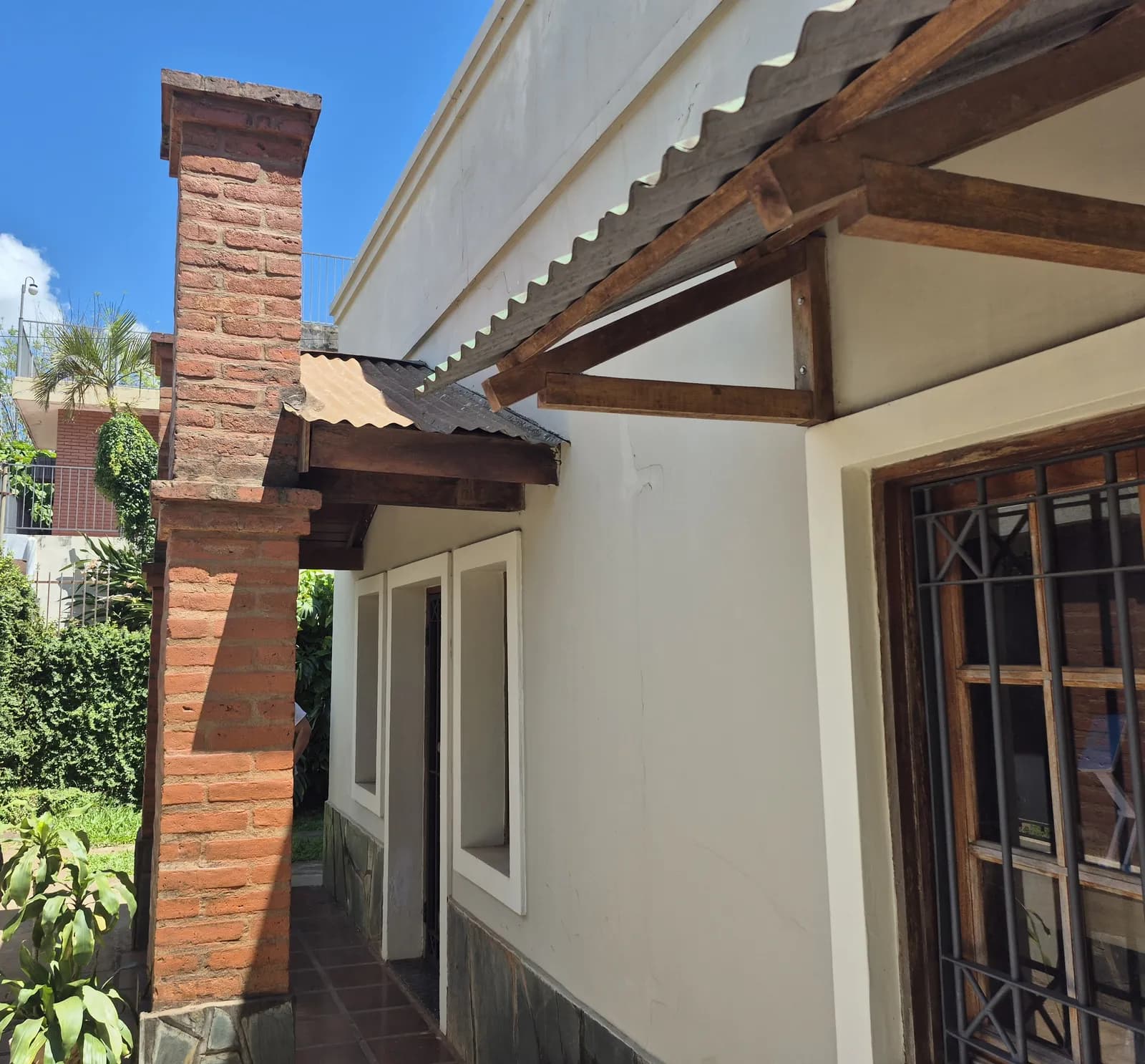 Fachada lateral con chimenea de ladrillo
