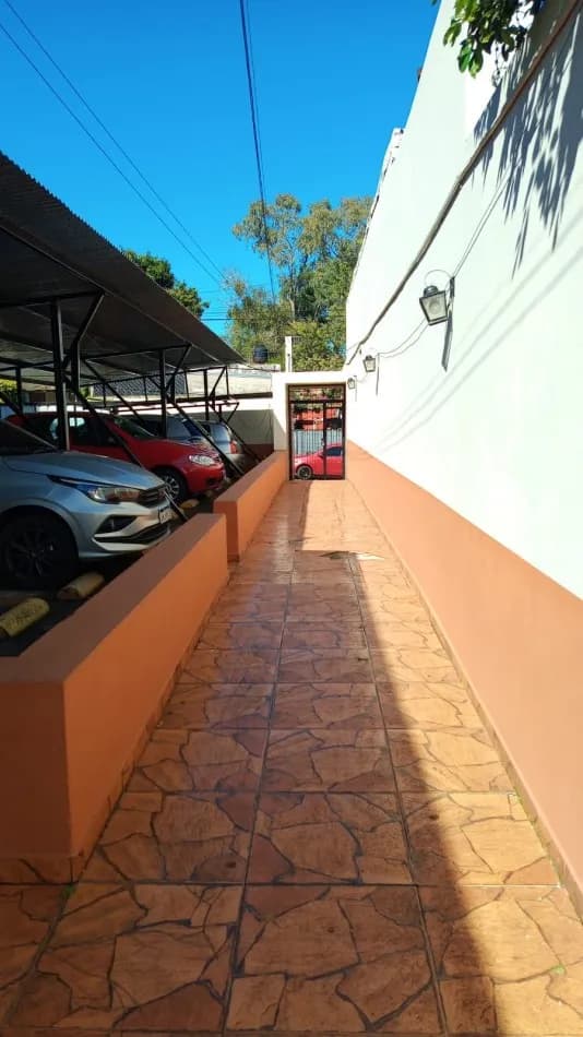 Pasillo exterior con estacionamiento techado